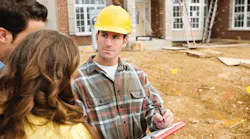 Couple with construction manager wearing a hard hat