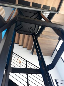 The Steel Frame Of The Integrated Hoistway Being Installed Within The Winding Staircase The Steel Frame Of The Integrated Hoistway Being Installed Within The Winding Staircase