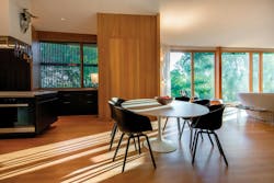 An open-concept living room and kitchen in a pavilion-like space features direct sets An open-concept living room and kitchen in a pavilion-like space features direct sets