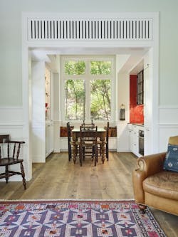 Translucent entry doors align with a large kitchen window bringing in the greenery and increasing visual space by letting the sightlines extend beyond the walls. Translucent entry doors align with a large kitchen window bringing in the greenery and increasing visual space by letting the sightlines extend beyond the walls.