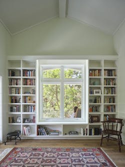 Bookshelves around the large windows keeps the massive storage piece from overpowering the space. Bookshelves around the large windows keeps the massive storage piece from overpowering the space.