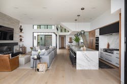 Where the courtyard cuts into the floor plan, a rectangular dining area separates the open kitchen and great room from the entryway, guest suite, and two-car garage. Clear white oak floors throughout the house provide a light foil to the heaviness of board-formed concrete fireplace surrounds and dark millwork. Where the courtyard cuts into the floor plan, a rectangular dining area separates the open kitchen and great room from the entryway, guest suite, and two-car garage. Clear white oak floors throughout the house provide a light foil to the heaviness of board-formed concrete fireplace surrounds and dark millwork.