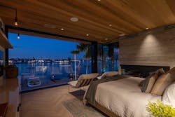 Western Red cedar continues seamlessly from beneath the second-story eaves into the owner’s bedroom. Patterson explains how they’d cut single planks of the wood and install it on either side of the window for perfectly matched grain enhancing the illusion of an uninterrupted plane connecting inside to out. Western Red cedar continues seamlessly from beneath the second-story eaves into the owner’s bedroom. Patterson explains how they’d cut single planks of the wood and install it on either side of the window for perfectly matched grain enhancing the illusion of an uninterrupted plane connecting inside to out.