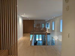 Slotted wood screens throughout the house serve as light accents and dividers but also conceal doors on the third floor. Slotted wood screens throughout the house serve as light accents and dividers but also conceal doors on the third floor.