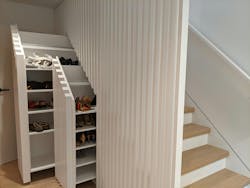 Sleek details give the home a contemporary look but also add usefulness to otherwise overlooked spaces, such as a cantilevered stair tread custom display shelf, and a custom shoe benches that roll out from underneath another stairwell. Sleek details give the home a contemporary look but also add usefulness to otherwise overlooked spaces, such as a cantilevered stair tread custom display shelf, and a custom shoe benches that roll out from underneath another stairwell.