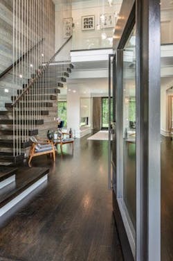 Steel rods act as decor and as support for floating steel stairway Steel rods act as decor and as support for floating steel stairway