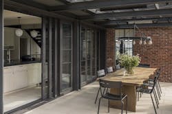 Moving the kitchen to the back of the house created an opportunity for indoor/outdoor living, with slide-and-stack window walls connecting the kitchen to a sheltered dining porch. Moving the kitchen to the back of the house created an opportunity for indoor/outdoor living, with slide-and-stack window walls connecting the kitchen to a sheltered dining porch.