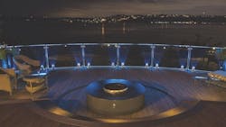 Deck with fire pit feature and night time view of the bay Deck with fire pit feature and night time view of the bay