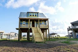 Cape Cod-style home on pilings sheathed in ForceField® Weather Barrier System with visible gold ForceField® Premium Tape. Cape Cod-style home on pilings sheathed in ForceField® Weather Barrier System with visible gold ForceField® Premium Tape.