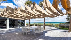 Heavy fabric hung between four palm trees was used to create a shaded area in place of a pergola. Heavy fabric hung between four palm trees was used to create a shaded area in place of a pergola.