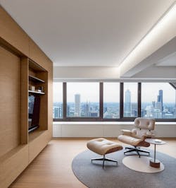 living room with eames chair, built-in cabinets, and view of Chicago living room with eames chair, built-in cabinets, and view of Chicago