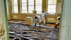 Ripping up hardwood floor in Marshall High Studios after hurricane Ripping up hardwood floor in Marshall High Studios after hurricane