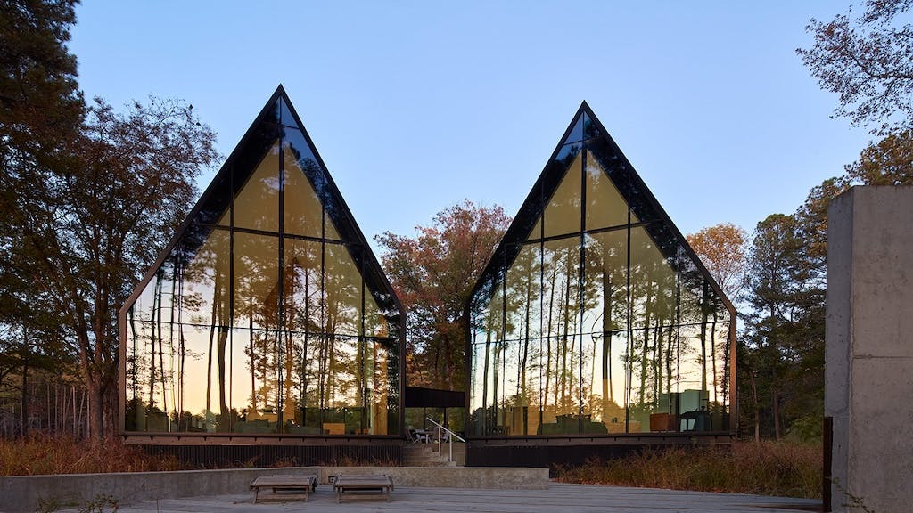 Steeplechase House with steep gabled roof forms and reflective glass panels
