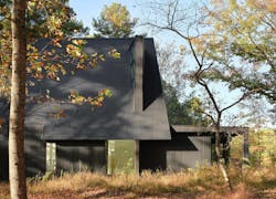 Steeplechase House exterior clad in dark corrugated metal panels Steeplechase House exterior clad in dark corrugated metal panels