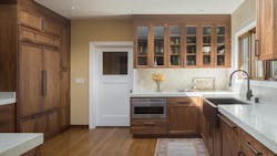 A fridge hidden behind wooden cabinetry A fridge hidden behind wooden cabinetry