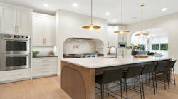 A large kitchen. with island and uniquely shaped vent hood A large kitchen. with island and uniquely shaped vent hood