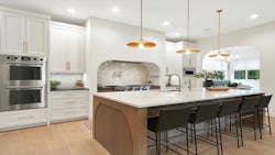 A large kitchen. with island and uniquely shaped vent hood A large kitchen. with island and uniquely shaped vent hood