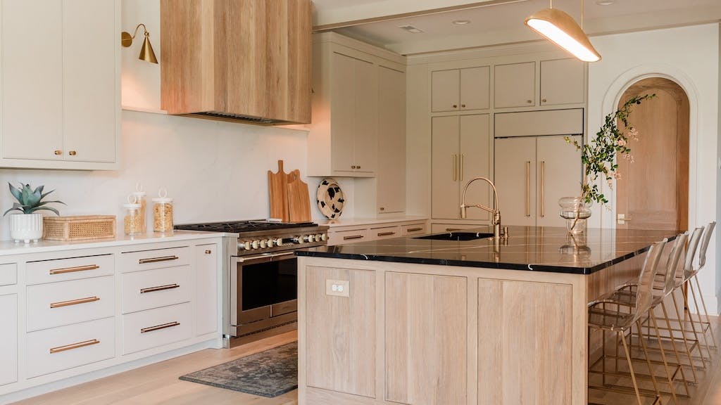 With the goal of achieving a modern organic design style, the designers behind this custom kitchen opted for neutral tones, heavy texture, and natural light.