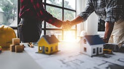 Builders shaking hands after a meeting Builders shaking hands after a meeting