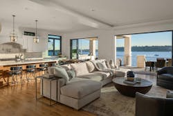 A living room with large windows and a balcony, showing an example of indoor-outdoor space A living room with large windows and a balcony, showing an example of indoor-outdoor space
