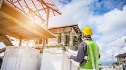 Home builder looks over plans at a jobsite as wage growth for residential professionals slows. Home builder looks over plans at a jobsite as wage growth for residential professionals slows.