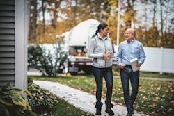 Homeowner walking with propane supplier | Custom Builder Homeowner walking with propane supplier | Custom Builder