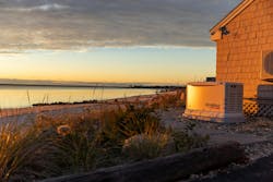 Sun setting on a home with a propane powered generator Sun setting on a home with a propane powered generator