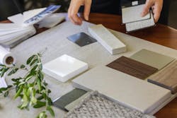 Designer laying out a sample board of selections for a client Designer laying out a sample board of selections for a client