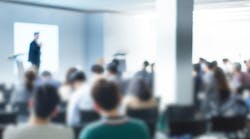 Blurred abstract image of a conference room with attendees Blurred abstract image of a conference room with attendees