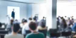 Blurred abstract image of a conference room with attendees Blurred abstract image of a conference room with attendees