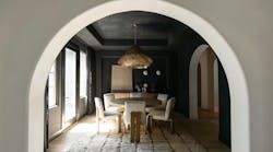 Interior arch leading to a dining room with walls and ceiling in black limewash | wabi sabi styled home in Scottsdale Interior arch leading to a dining room with walls and ceiling in black limewash | wabi sabi styled home in Scottsdale