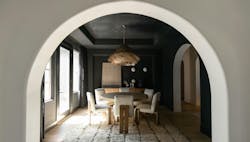 Interior arch leading to a dining room with walls and ceiling in black limewash | wabi sabi styled home in Scottsdale Interior arch leading to a dining room with walls and ceiling in black limewash | wabi sabi styled home in Scottsdale