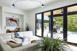Living room showing sliding glass doors that lead to the outdoor space Living room showing sliding glass doors that lead to the outdoor space