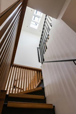 View up a central stairway of a penthouse duplex, showing the skylight in the ceiling of the floor above. View up a central stairway of a penthouse duplex, showing the skylight in the ceiling of the floor above.