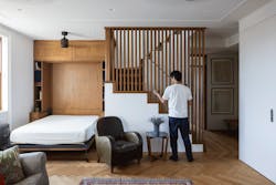 GIF Image of a person shifting the wooden lovers on a staircase that creates a solid wall to transform this living room into a guest room. GIF Image of a person shifting the wooden lovers on a staircase that creates a solid wall to transform this living room into a guest room.