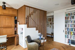 View of a living room with wooden louvers on the staircase View of a living room with wooden louvers on the staircase