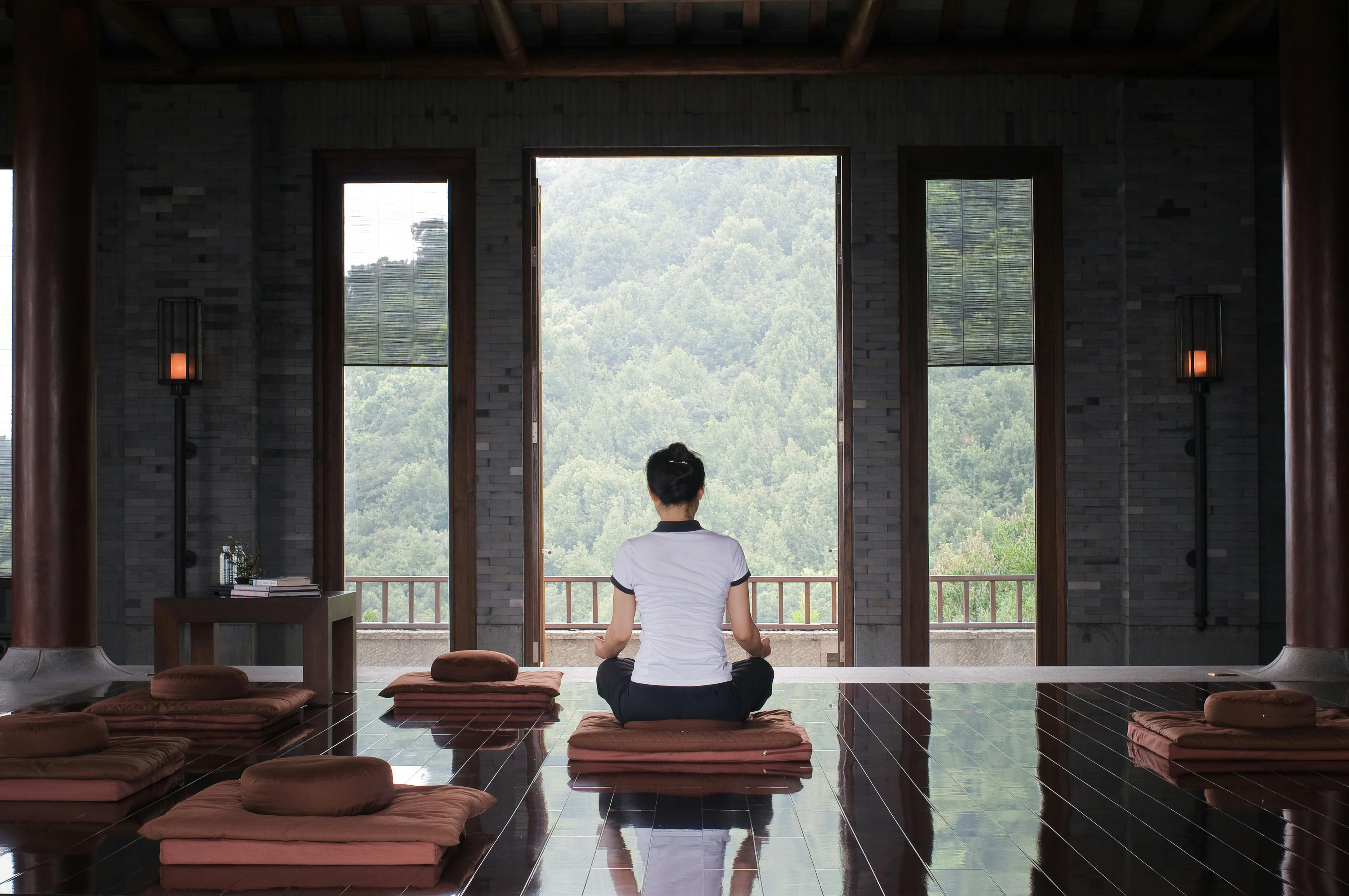 Image of a person doing yoga in a luxury home
