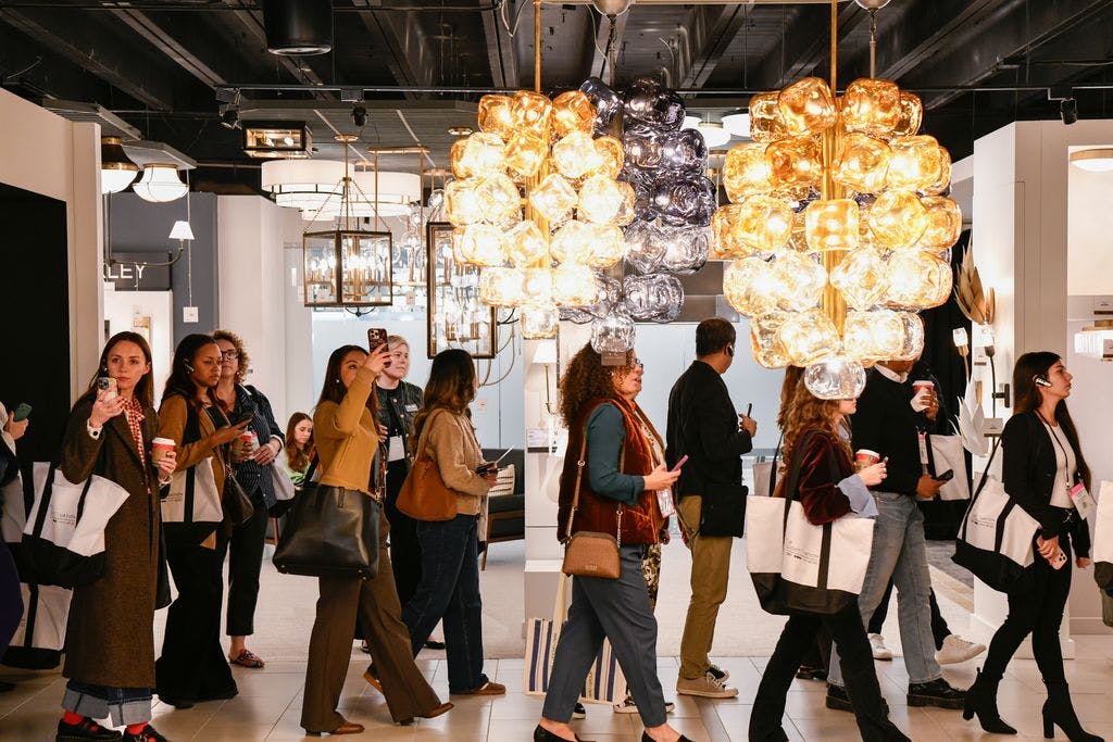Designers walking through a showroom at the Dallas Market Center's Lightovation lighting event