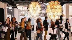 Designers walking through a showroom at the Dallas Market Center's Lightovation lighting event Designers walking through a showroom at the Dallas Market Center's Lightovation lighting event