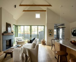 The design team opted for an open-concept kitchen and living room with a double-height ceiling and large glass doors that make the space seem larger than it actually is. The design team opted for an open-concept kitchen and living room with a double-height ceiling and large glass doors that make the space seem larger than it actually is.