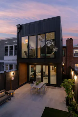 A two-story addition clad in black fiber cement siding expands the interiors while still leaving ample outdoor entertainment space.