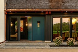 Painted deep teal, the front door stands out against the white stucco façade, clearly marking the home’s entry. Painted deep teal, the front door stands out against the white stucco façade, clearly marking the home’s entry.
