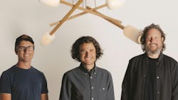 Headshot of the founders of Cerno Group, with one of their chandeliers in the background Headshot of the founders of Cerno Group, with one of their chandeliers in the background