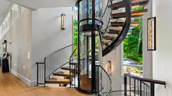 Wrapped around a glass elevator, this staircase posed a unique challenge: create an open, visually interesting design while remaining structurally sound.