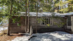 A 1915 log cabin, surrounded by a hodgepodge of poorly executed additions. A 1915 log cabin, surrounded by a hodgepodge of poorly executed additions.