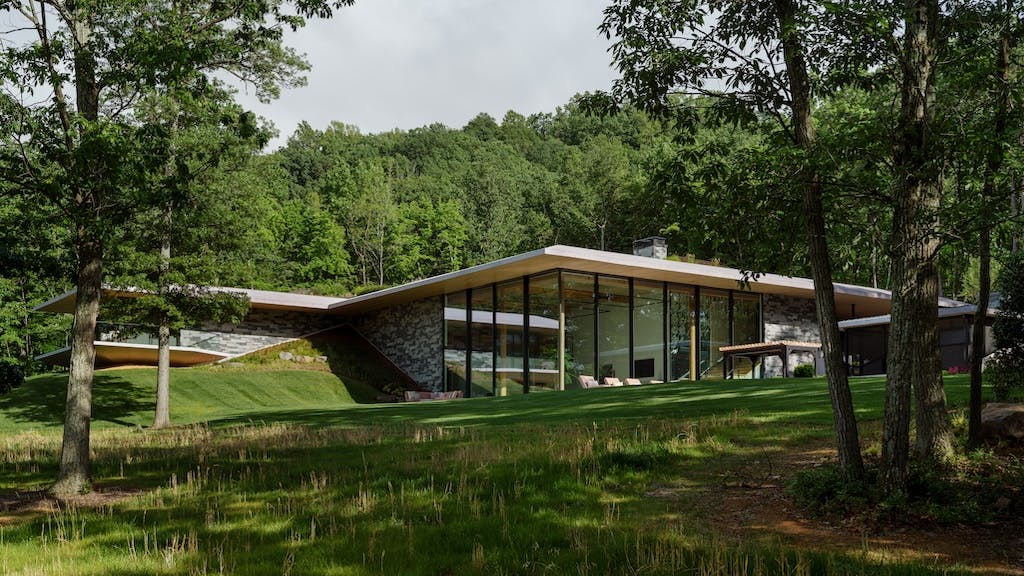 Home built by Gruver Cooley, sinking into the sloped site