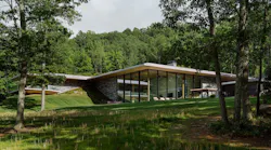 Home built by Gruver Cooley, sinking into the sloped site Home built by Gruver Cooley, sinking into the sloped site