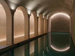 An underground pool and spa feature hand-stamped walls and star-like ceiling lights. An underground pool and spa feature hand-stamped walls and star-like ceiling lights.