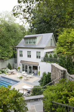 The design team used traditional forms and a complementary color palette to ensure the guest house matched the main home. The design team used traditional forms and a complementary color palette to ensure the guest house matched the main home.