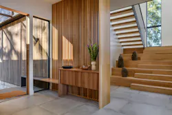 While a dark corrugated metal defines the home's exteriors, the insides are warm and bright.